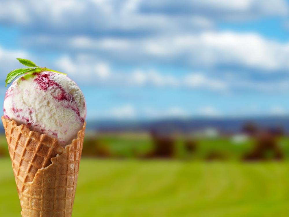 Ice cream on sunny countryside background